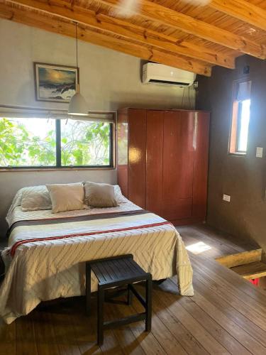 a bedroom with a bed and a table in it at Casa Quinta Ecológica "Coruya Wild" in Santa Ana