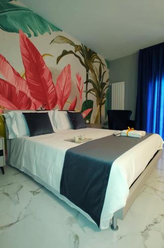 a bedroom with a large bed with a painting on the wall at Luxury Melo Apartment in Bari