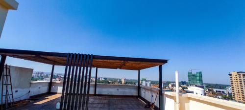 a balcony with a view of a city at Stone Age Nairobi --- Rooftop Pool & Lounge, Gym, Games room, Office Space in Nairobi