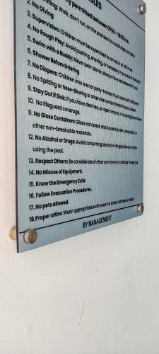 a sign on a wall with numbers on it at Stone Age Nairobi --- Rooftop Pool & Lounge, Gym, Games room, Office Space in Nairobi