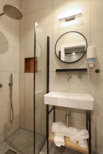 a bathroom with a sink and a mirror at Ein Harod Country Lodge in ‘En H̱arod