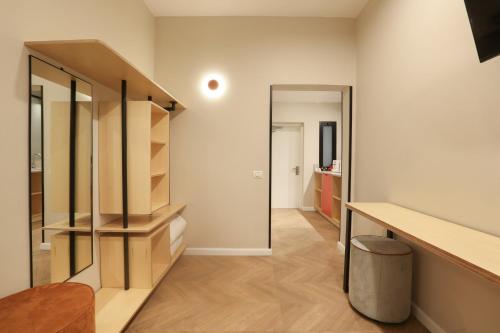 a living room with a staircase and a mirror at Ein Harod Country Lodge in ‘En H̱arod