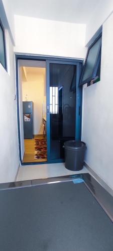a room with a large glass door to a bathroom at Stone Age Nairobi --- Rooftop Pool & Lounge, Gym, Games room, Office Space in Nairobi