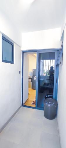 a hallway with a door open to a room at Stone Age Nairobi --- Rooftop Pool & Lounge, Gym, Games room, Office Space in Nairobi