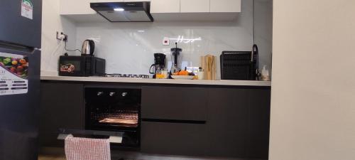 a kitchen with a counter top with an oven at Stone Age Nairobi --- Rooftop Pool & Lounge, Gym, Games room, Office Space in Nairobi