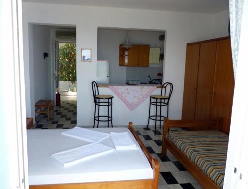 a kitchen with a table and chairs in a room at Manthos in Kalloni