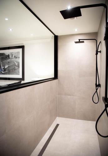 a bathroom with a shower and a window at The Hotel Chester in Chester