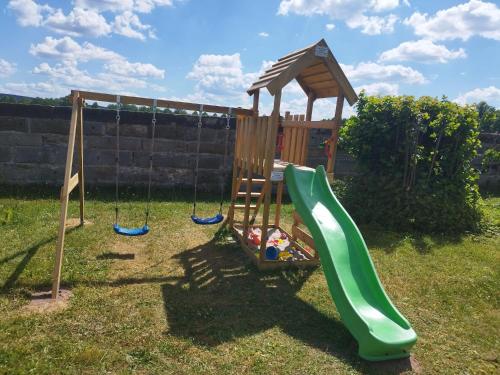 a playground with a slide in a yard at Schloss Hotel Colmdorf in Bayreuth