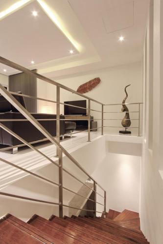 a spiral staircase in a house with a vase at Luxury villa, Seaview, Private Pool in Plai Laem