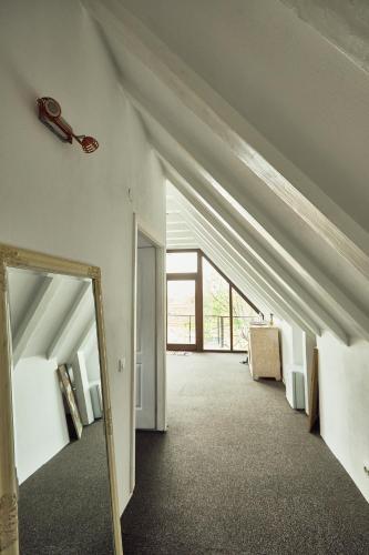 an attic hallway with a mirror and a mirror at Casa Thea Cheile Nerei in Socolari