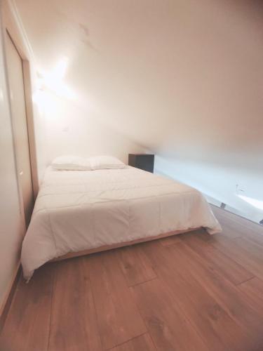 - un lit blanc dans une chambre dotée de parquet dans l'établissement Atypique, cœurdeSouillac, tidordognehomes, à Souillac
