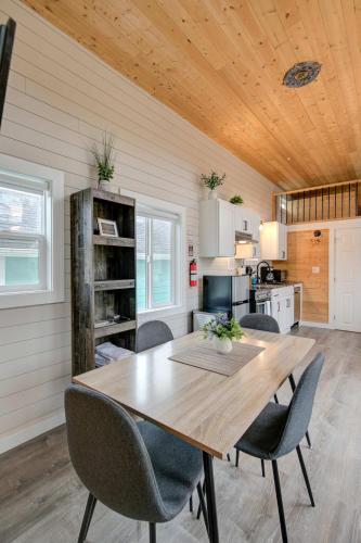 a dining room with a wooden table and chairs at Cozy Loft Tiny House by Ocean Spray Beach in Grayland