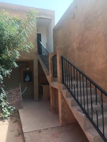 a set of stairs leading up to a house at Keur Mamina in Warang