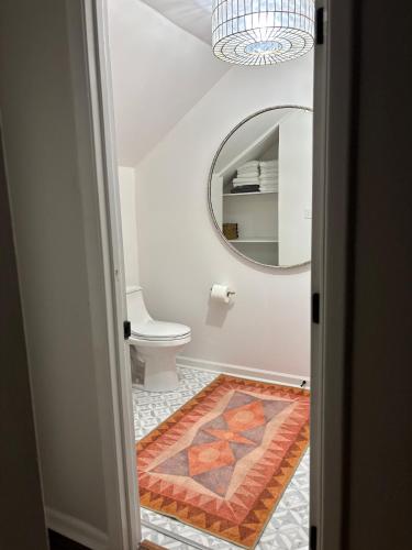 a bathroom with a toilet and a mirror at The Tee Box at Seabrook Island in Johns Island