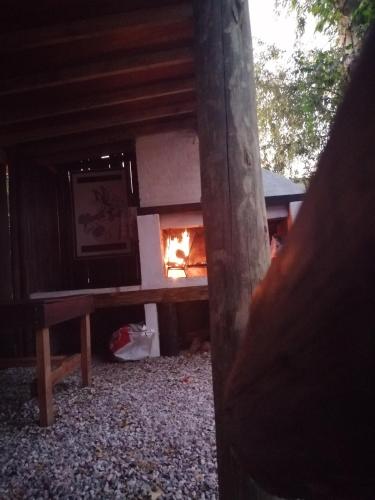 a fire burns in a fireplace in a house at El Tucán 1 in Punta Del Diablo