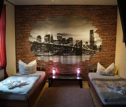 a room with two beds and a mural of a city at Haus Oberkassel in Bonn