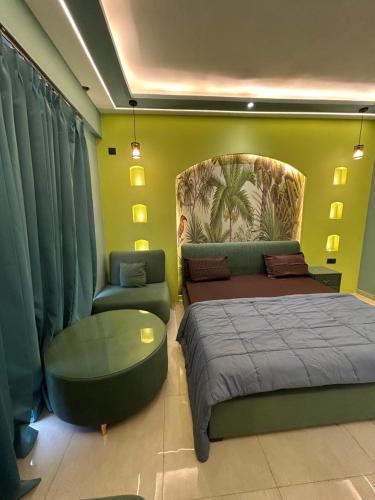 a bedroom with a bed and a couch and a chair at Leisure homes in Lucknow