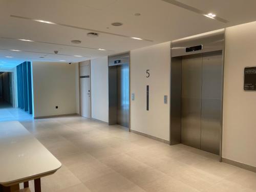 an empty hallway with elevators in a building at 1 Bedroom Apartment at Marassi Vista Residence in Muharraq