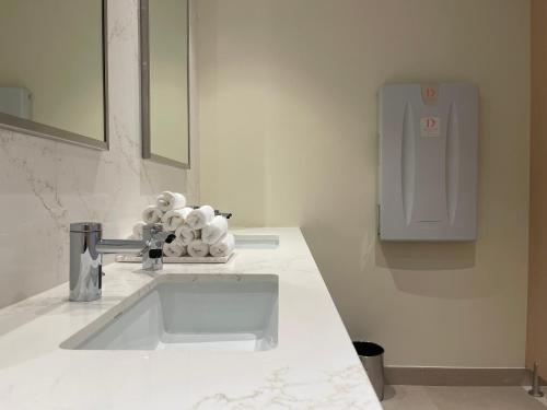a bathroom counter with a sink and a mirror at 1 Bedroom Apartment at Marassi Vista Residence in Muharraq