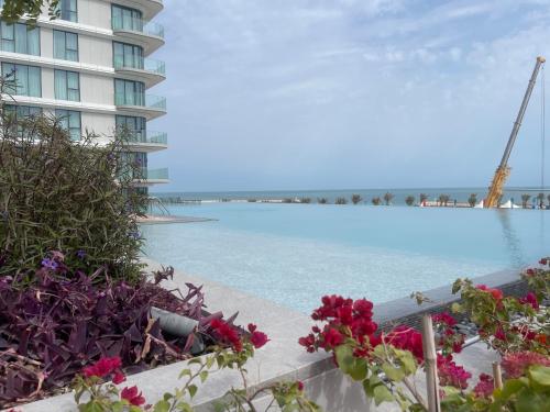 a view of the water in front of a building at 1 Bedroom Apartment at Marassi Vista Residence in Muharraq