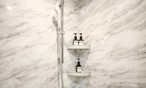 a bathroom with a sink with two bottles of wine at ルチル池袋東京 in Tokyo