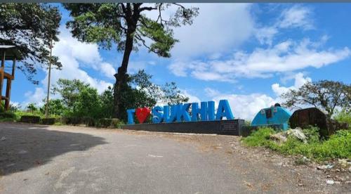 a sign for a hollywood sign on the side of a road at Mane Dara homestay in Darjeeling