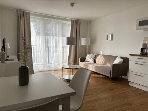 a living room with a couch and a table at Ferienwohnung-Domziegelhof in Schleswig