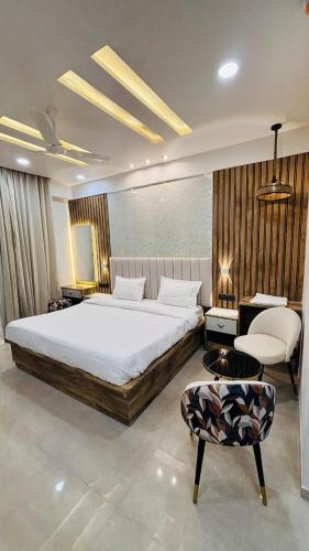 a bedroom with a large bed and a chair at Leisure homes in Lucknow