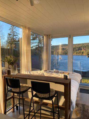 a bedroom with a bed and a large window at Gnist Retreat in Lillestrøm
