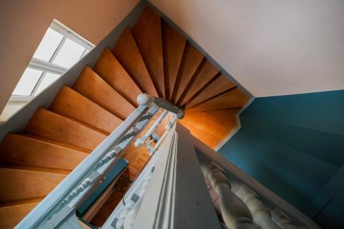 a staircase in a house with a wooden ceiling at La Chapelle, Les Suites du Palais, l'unique 5 étoiles de Nevers, Suite d'Exception, by PRIMO C0NCIERGERIE in Nevers