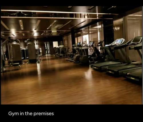 a gym with a row of treadmills and machines at The Manor in Pune