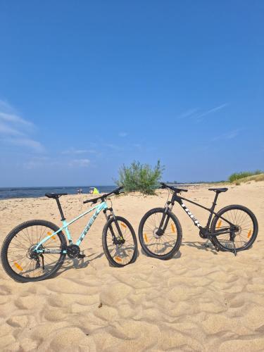 two bikes are parked on the beach at Domek pod Grabami in Gdańsk