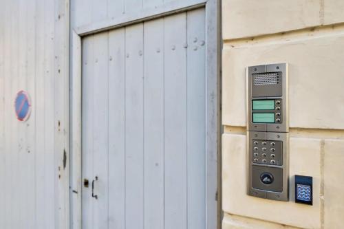 a remote control attached to a building with a door at La Chapelle, Les Suites du Palais, l'unique 5 étoiles de Nevers, Suite d'Exception, by PRIMO C0NCIERGERIE in Nevers