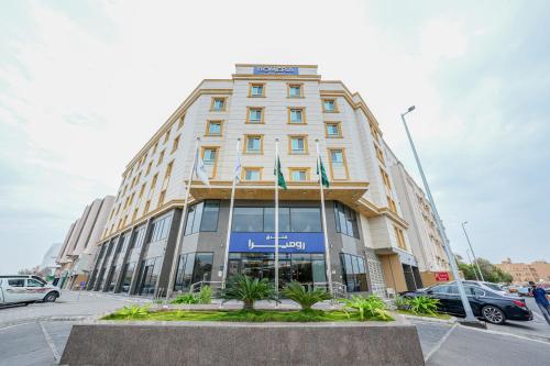a tall building with a sign on top of it at Romera Hotel in Jeddah