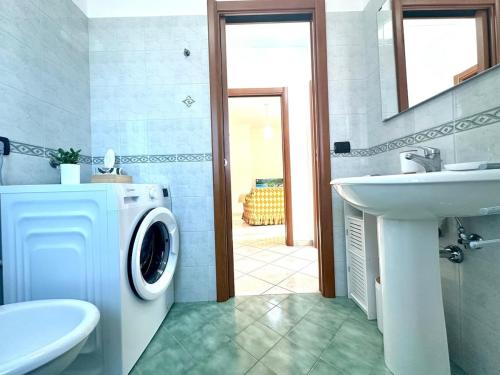 a bathroom with a washing machine and a sink at Casa Vacanze Zia Flora in Avellino