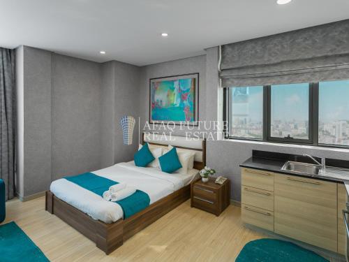 a bedroom with a bed and a sink at Vita Tower in Manama