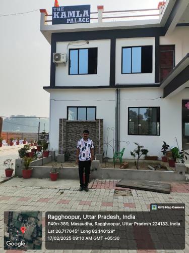 a man standing in front of a house at The kamla palace in Masodha
