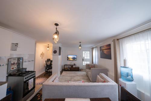 a living room with a couch and a tv at 16 Arabella Nova near Waterfront Mall - Karen in Karen