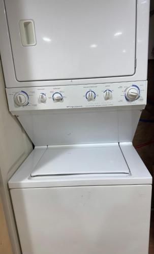 a white refrigerator freezer sitting in a kitchen at Private Guest House-Lake Ronkonkoma in Ronkonkoma