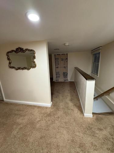 an empty room with a mirror on the wall at Private Guest House-Lake Ronkonkoma in Ronkonkoma