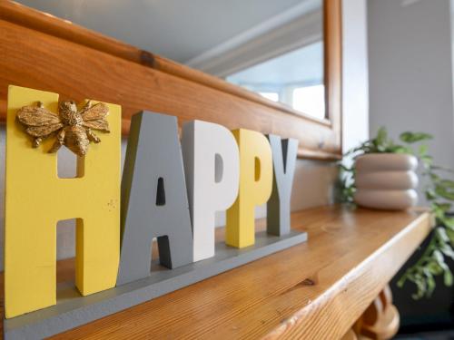 a sign for a happy sign on a shelf at Pass the Keys Brighouse Central - Ideal For Workers in Brighouse