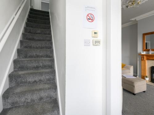 a stairway in a home with a gray staircase at Pass the Keys Brighouse Central - Ideal For Workers in Brighouse