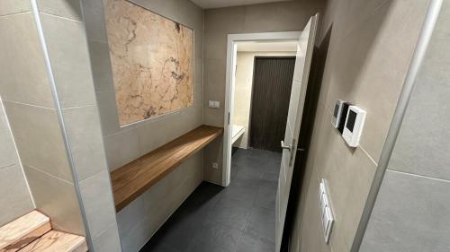 a bathroom with a walk in shower and a hallway at CHATA Privlaky in Přívlaky