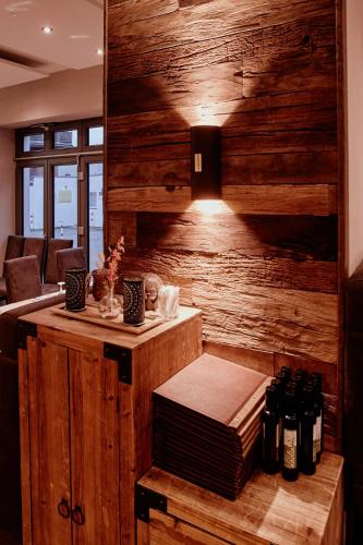 a room with wooden walls and a table and a couch at cityhotel in Bocholt