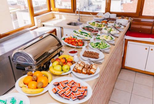a kitchen counter filled with lots of different types of food at Hotel Saba in Istanbul