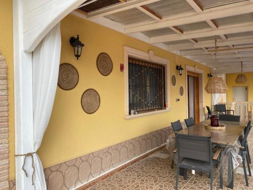 una sala da pranzo con tavolo e sedie su una casa di Maison typique avec vue dégagée sur la vallée a Fortuna