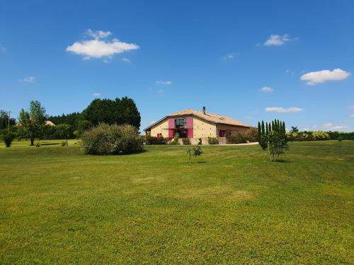 a house in the middle of a green field at exceptionnel loft style industriel tout équipé 15 personnes avec piscine et jacuzzi in Villebramar