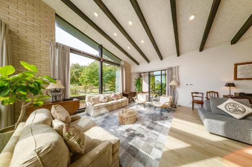 a living room with a couch and a table at Hakuba Jolie Maison by Jade Group in Hakuba