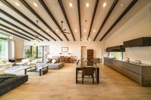 a living room with a couch and a table at Hakuba Jolie Maison by Jade Group in Hakuba