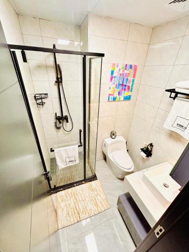 a bathroom with a shower and a toilet at Studio 19 Diamond-2bedroom apartment in Gaborone